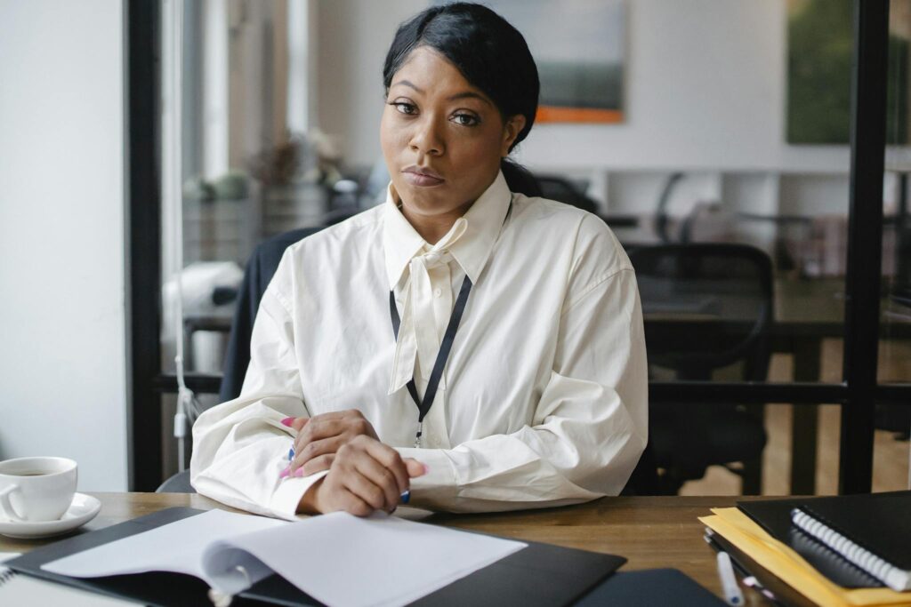 Confident businesswoman working at her desk in a modern office setting, focusing on an important task.